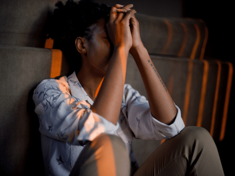 Black woman bearing stress of domestic violence.