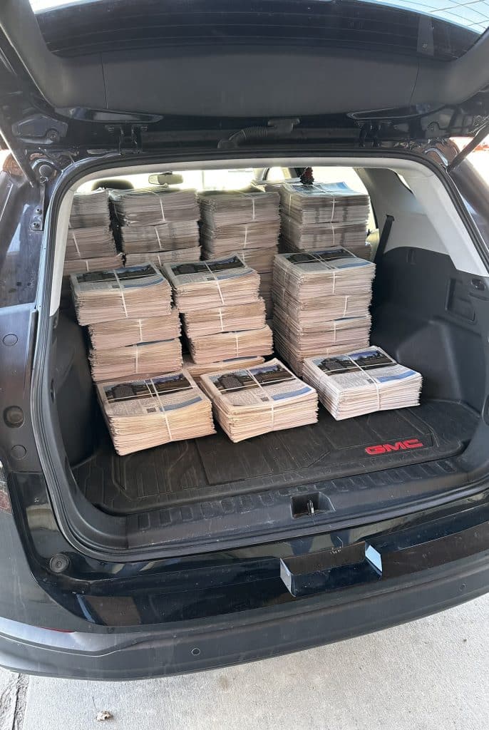 Black Iowa Newspaper winter edition in the back of the SUV. 
